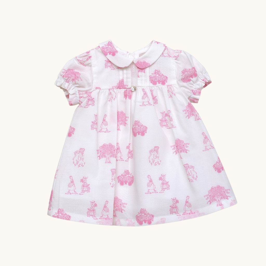 Vestido Angélique de algodón blanco con estampado rosa de Magic Place Kids, cuello bebé y mangas abullonadas.